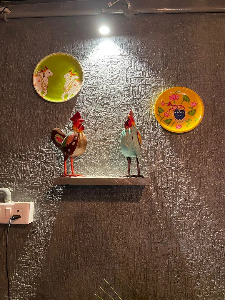Hand-painted plates and folk roosters on a textured wall